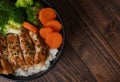 Japanese Food Style : Top view of Homemade Chicken Teriyaki grilled with rice , carrot , broccoli put on the black bowl and place Royalty Free Stock Photo