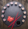 Japanese food, sushi with salmon and tuna, fresh ginger, soy sauce and chopsticks lined up on tray of chalk boards, frame, space Royalty Free Stock Photo