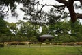 A Japanese garden filled with green trees, flower bushes and a tea house in spring at Nijo Castle, Kyoto, Japan Royalty Free Stock Photo