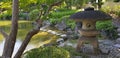 Japanese garden lantern and pond in summer Royalty Free Stock Photo