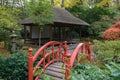 Autumn hues Japanese Garden, red bridge and chashitsu tea house for tea ceremony Royalty Free Stock Photo