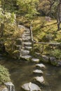 Japanese garden with a stone path across the river. Royalty Free Stock Photo