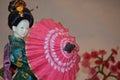 Japanese geisha doll with umbrella.. Royalty Free Stock Photo