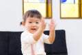 Japanese girl dancing with expressive hand movements in living room