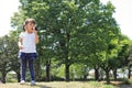 Japanese girl blowing dandelion seeds under the blue sky Royalty Free Stock Photo