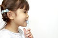 Japanese girl brushing her teeth Royalty Free Stock Photo