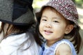 Japanese girl carried in her mother`s back