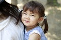 Japanese girl carried in her mother`s back