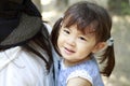 Japanese girl carried in her mother`s back