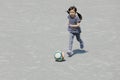 Japanese girl dribbling soccer ball Royalty Free Stock Photo