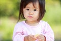 Japanese girl eating rice cracker Royalty Free Stock Photo