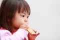 Japanese girl eating rice cracker Royalty Free Stock Photo