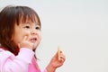 Japanese girl eating rice cracker Royalty Free Stock Photo