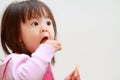 Japanese girl eating rice cracker Royalty Free Stock Photo