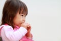 Japanese girl eating rice cracker Royalty Free Stock Photo