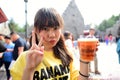 Japanese girl holding Plastic glass of Butter beer