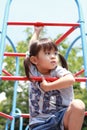 Japanese girl on the jungle gym Royalty Free Stock Photo