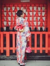 Japanese girl with Kimono happiness at Fushimi Inari Shrine.