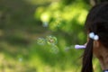 Japanese girl playing with bubble in the green Royalty Free Stock Photo