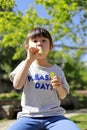 Japanese girl playing with bubble in the green Royalty Free Stock Photo