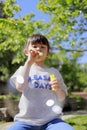 Japanese girl playing with bubble in the green Royalty Free Stock Photo