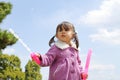 Japanese girl playing with bubble under the blue sky Royalty Free Stock Photo