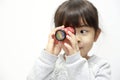 Japanese girl playing with kaleidoscope Royalty Free Stock Photo