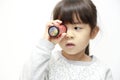 Japanese girl playing with kaleidoscope Royalty Free Stock Photo