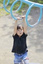 Japanese girl playing with a monkey bars Royalty Free Stock Photo