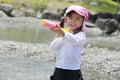 Japanese girl playing in the river Royalty Free Stock Photo