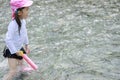 Japanese girl playing in the river with water gun Royalty Free Stock Photo