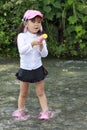 Japanese girl playing in the river with water gun Royalty Free Stock Photo