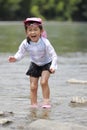 Japanese girl playing in the river Royalty Free Stock Photo