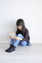 Japanese girl playing with video game console on the floor Royalty Free Stock Photo