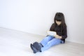 Japanese girl playing with video game console on the floor Royalty Free Stock Photo