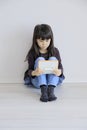 Japanese girl playing with video game console on the floor Royalty Free Stock Photo