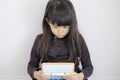 Japanese girl playing with video game console on the floor Royalty Free Stock Photo