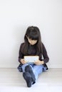 Japanese girl playing with video game console on the floor Royalty Free Stock Photo