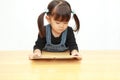 Japanese girl reading a picture book Royalty Free Stock Photo