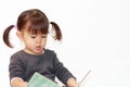 Japanese girl reading a picture book Royalty Free Stock Photo