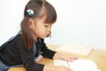 Japanese girl reading a picture book Royalty Free Stock Photo