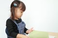 Japanese girl reading a picture book Royalty Free Stock Photo