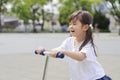 Japanese girl riding on a scooter