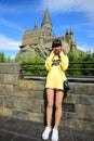 Japanese girl taking photo at The Hogwarts castle