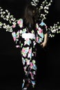 Japanese girl in traditional Japanese kimono, holds sprigs of ch