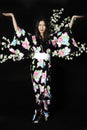 Japanese girl in traditional Japanese kimono, holds sprigs of ch