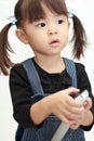 Japanese girl using remote controller Royalty Free Stock Photo