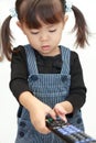 Japanese girl using remote controller Royalty Free Stock Photo