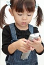 Japanese girl using remote controller Royalty Free Stock Photo