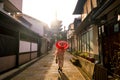 Japanese girl in Yukata with red umbrella in old town Kyoto